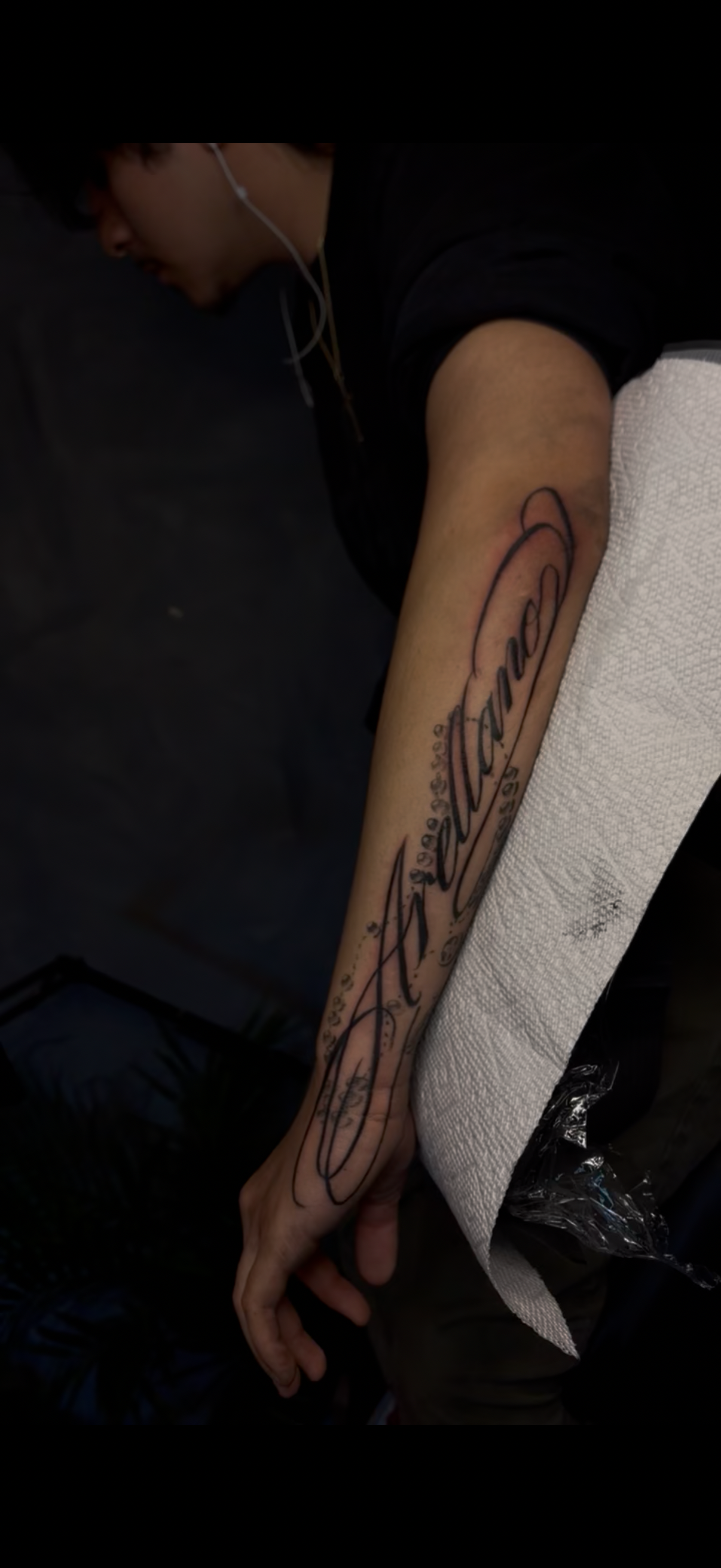 Arellano script lettering forearm tattoo