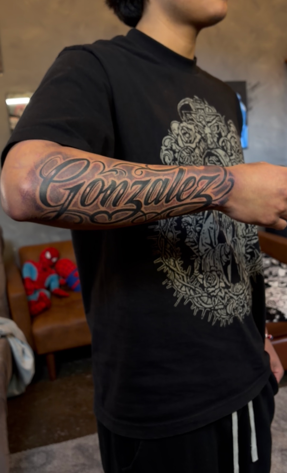 Gonzalez chicano lettering tattoo across the forearm
