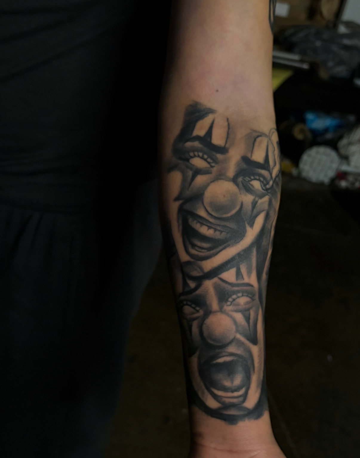 Laugh now cry later clowns forearm tattoo