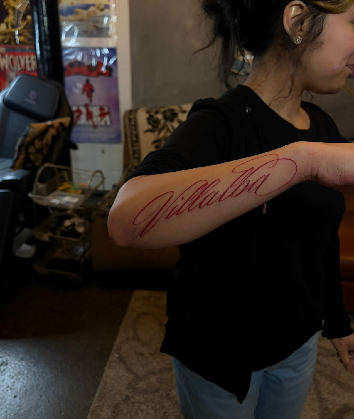 Villalba red ink script lettering forearm tattoo