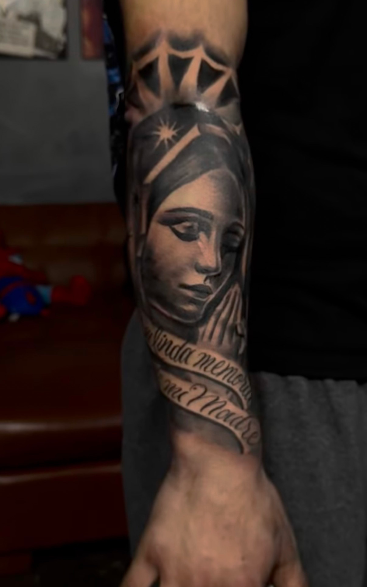 Virgin Mary with mi madre banner forearm tattoo