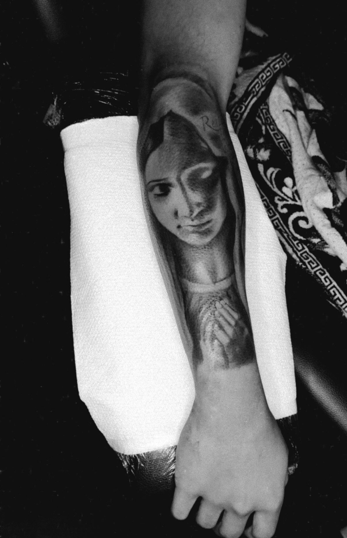 Virgin Mary portrait black and gray forearm tattoo